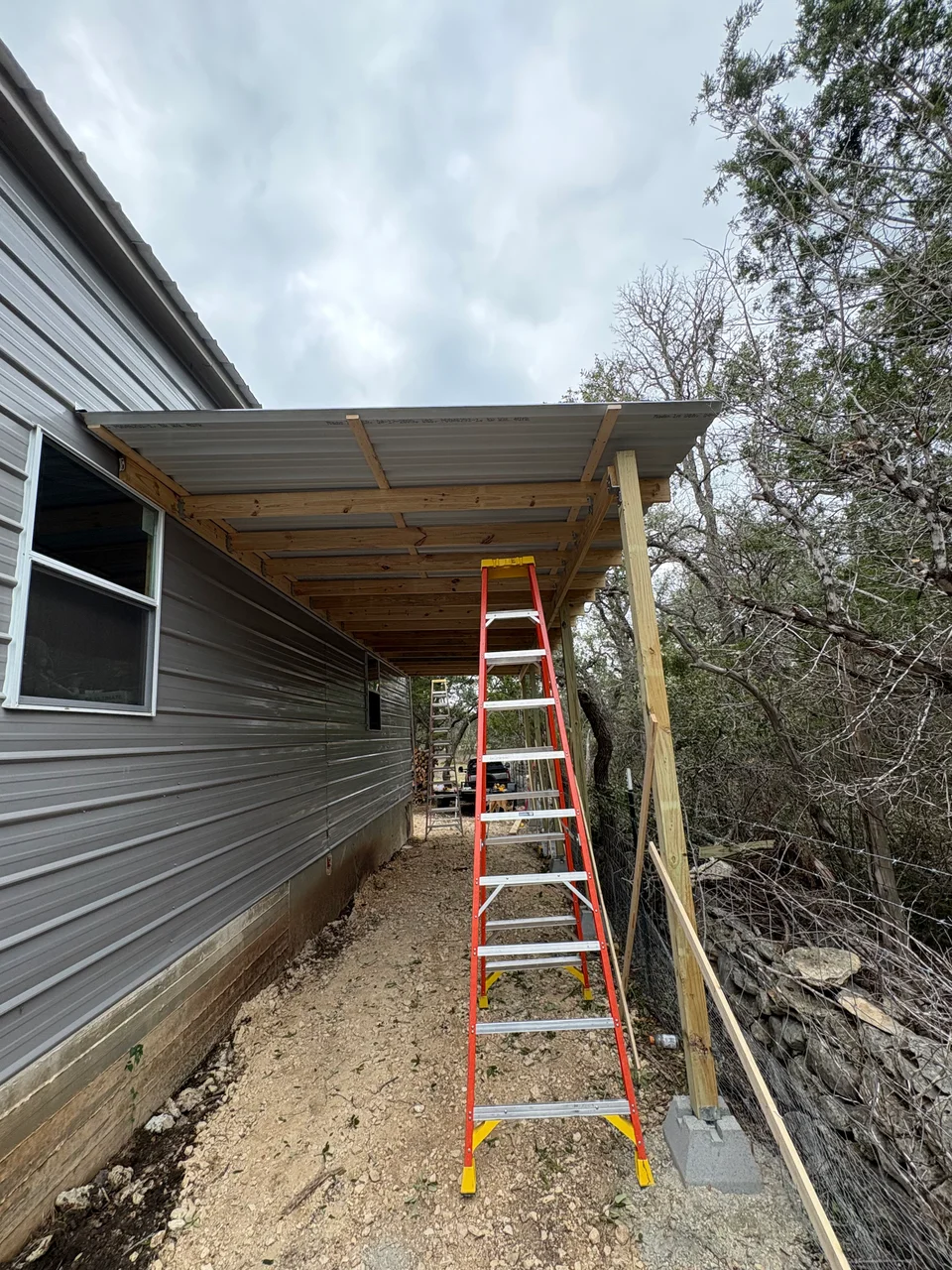 Before photo of side porch area prepared for under-porch storage enclosure in San Marcos, TX