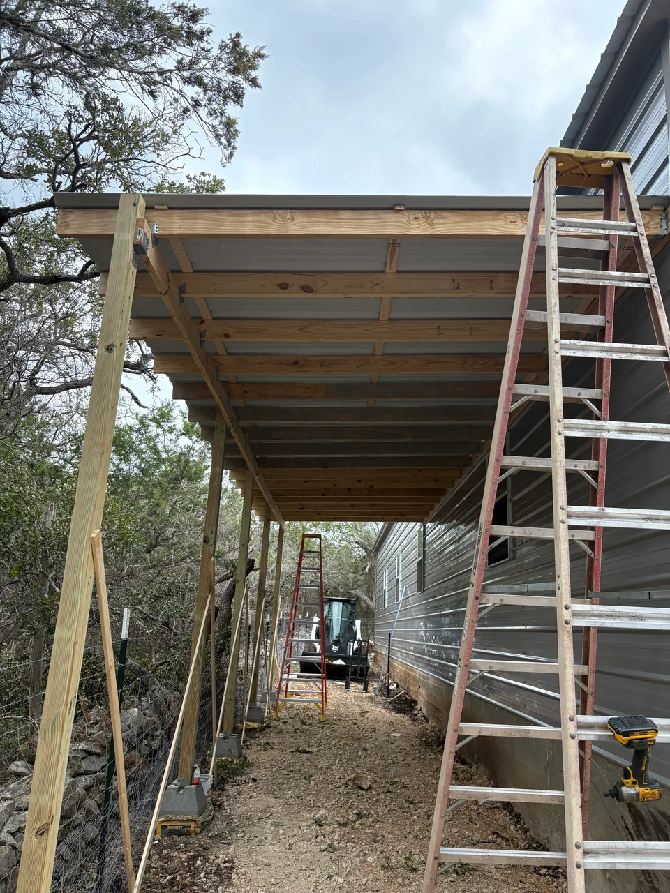 During construction photo showing framing progress for side porch storage enclosure